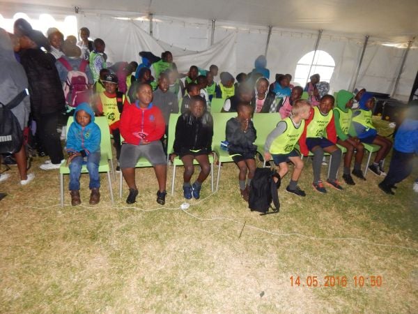 Picture of children sitting in a tent.
